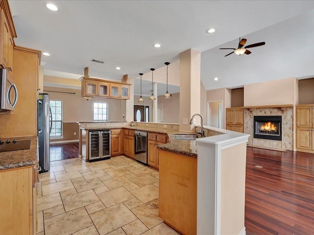 1904 Loblolly Ln, Lufkin, TX 75904 - kitchen with a sink, stainless steel appliances, beverage cooler, baseboards, and a high end fireplace