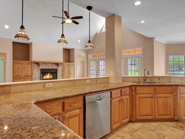 1904 Loblolly Ln, Lufkin, TX 75904 - kitchen featuring dishwasher, a sink, a ceiling fan, a premium fireplace, and light stone countertops