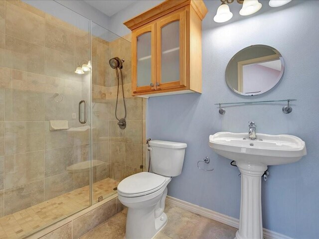 1904 Loblolly Ln, Lufkin, TX 75904 - bathroom with toilet, a stall shower, and baseboards