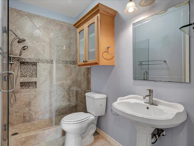 1904 Loblolly Ln, Lufkin, TX 75904 - bathroom featuring a shower stall, toilet, and baseboards