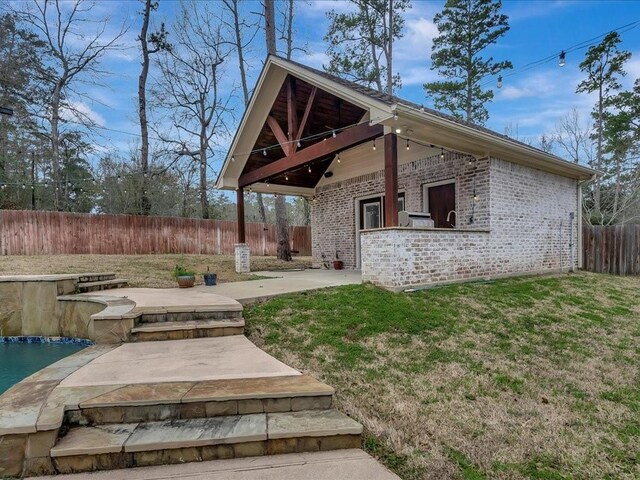 1904 Loblolly Ln, Lufkin, TX 75904 - back of house with brick siding and a patio area
