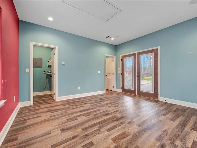 1904 Loblolly Ln, Lufkin, TX 75904 - empty room with french doors, attic access, wood finished floors, baseboards, and recessed lighting