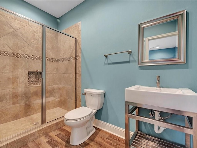 1904 Loblolly Ln, Lufkin, TX 75904 - full bathroom with a shower stall, toilet, wood finished floors, and baseboards