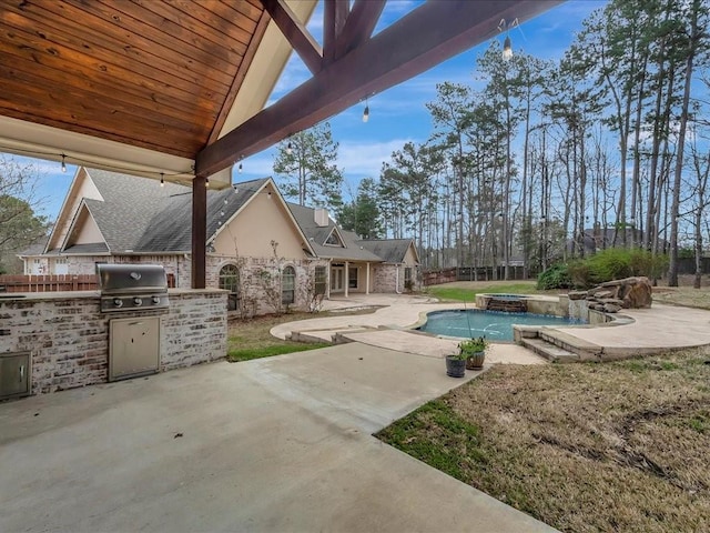1904 Loblolly Ln, Lufkin, TX 75904 - view of patio featuring an outdoor kitchen, a grill, an in-ground hot tub, an outdoor pool, and fence