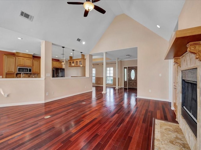 1904 Loblolly Ln, Lufkin, TX 75904 - unfurnished living room featuring a fireplace, ceiling fan, decorative columns, high vaulted ceiling, and wood finished floors