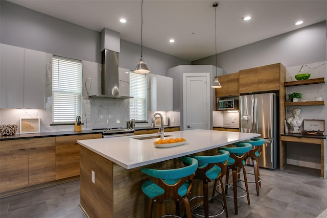2239 Lovedale Ave Unit 105, Dallas, TX 75235 - kitchen with a sink, stainless steel appliances, brown cabinetry, a kitchen breakfast bar, and modern cabinets