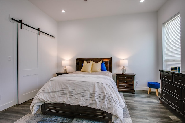 2239 Lovedale Ave Unit 105, Dallas, TX 75235 - bedroom featuring baseboards, recessed lighting, a barn door, and wood finished floors