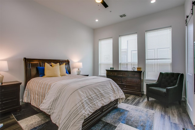 2239 Lovedale Ave Unit 105, Dallas, TX 75235 - bedroom with visible vents, a barn door, dark wood-type flooring, and recessed lighting