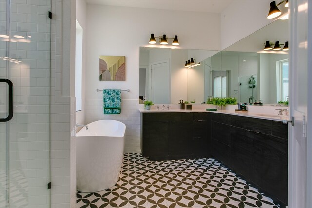 2239 Lovedale Ave Unit 105, Dallas, TX 75235 - full bathroom with a sink, a freestanding bath, double vanity, and a shower stall
