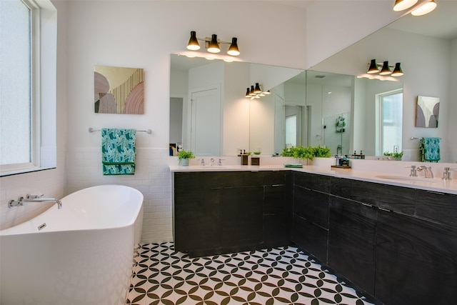 2239 Lovedale Ave Unit 105, Dallas, TX 75235 - bathroom featuring a sink, double vanity, a wealth of natural light, and a freestanding tub