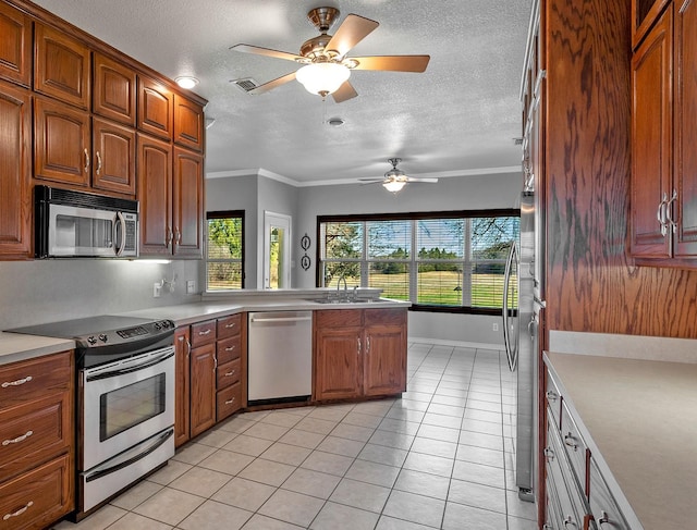 4489 E Fm 120, Denison, TX 75021 - kitchen featuring a textured ceiling, appliances with stainless steel finishes, a sink, and plenty of natural light