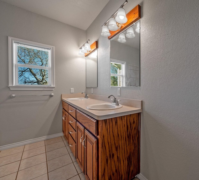 4489 E Fm 120, Denison, TX 75021 - full bathroom with a textured wall, double vanity, a sink, and tile patterned flooring
