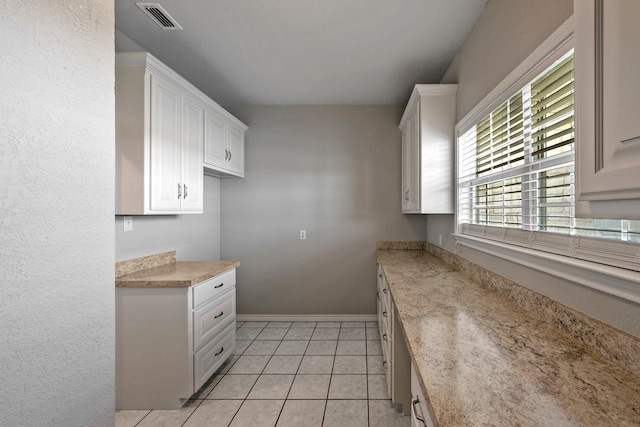 4489 E Fm 120, Denison, TX 75021 - kitchen featuring white cabinets, light tile patterned floors, visible vents, and baseboards