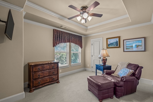 sitting room with a ceiling fan, a raised ceiling, crown molding, carpet flooring, and baseboards
