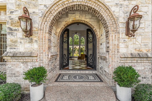 doorway to property with stone siding and brick siding