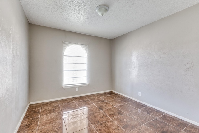 3816 Lauretta Dr, Fort Worth, TX 76119 - spare room with baseboards, a textured wall, and a textured ceiling