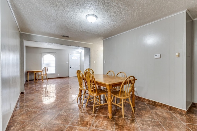 3816 Lauretta Dr, Fort Worth, TX 76119 - dining space featuring baseboards, visible vents, ornamental molding, and a textured ceiling