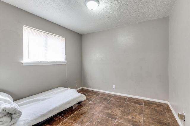 3816 Lauretta Dr, Fort Worth, TX 76119 - bedroom featuring baseboards and a textured ceiling