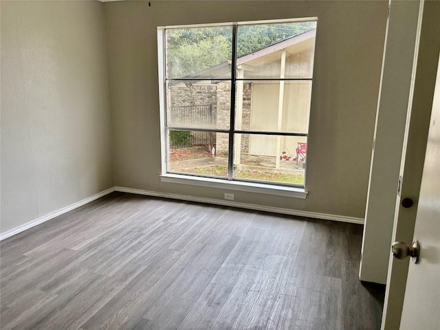 8805 N Normandale St, Fort Worth, TX 76116 - empty room featuring baseboards, wood finished floors, and plenty of natural light