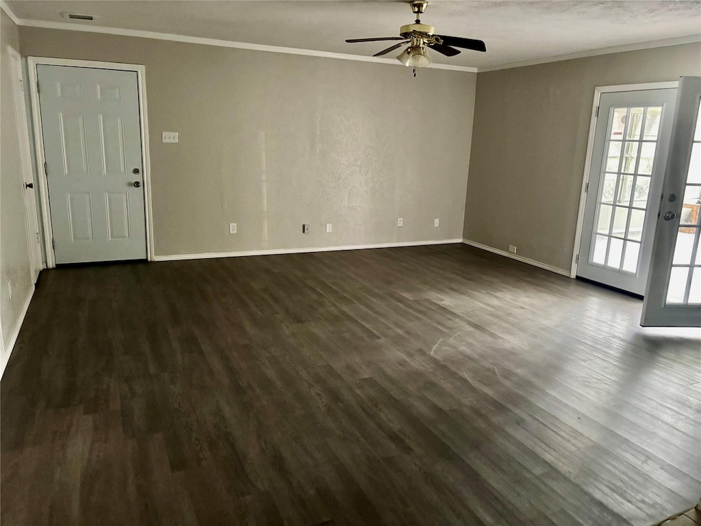 8805 N Normandale St, Fort Worth, TX 76116 - unfurnished living room featuring a ceiling fan, dark wood-style flooring, crown molding, and baseboards