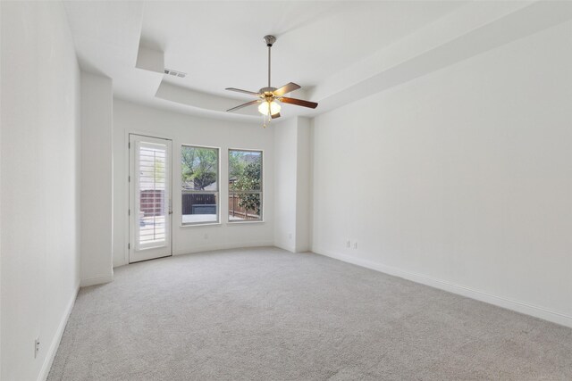 3612 Green Mountain Pl, Mckinney, TX 75070 - empty room featuring light carpet, ceiling fan, baseboards, and a tray ceiling