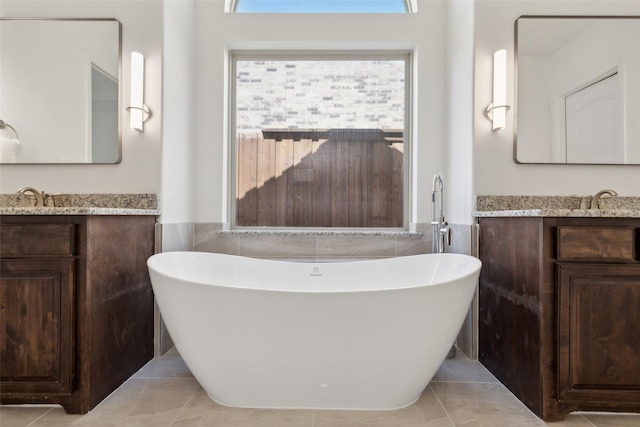 3612 Green Mountain Pl, Mckinney, TX 75070 - full bath featuring a freestanding bath, tile walls, vanity, tile patterned floors, and a wainscoted wall