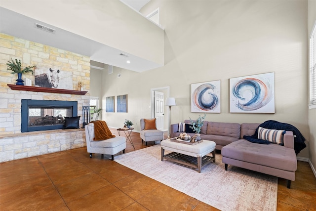 2357 S Branch Rd, Krum, TX 76249 - living area featuring a stone fireplace, tile patterned floors, and a towering ceiling