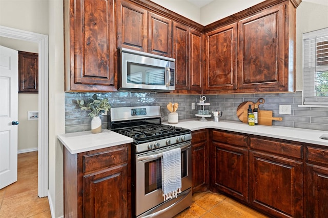 2357 S Branch Rd, Krum, TX 76249 - kitchen with appliances with stainless steel finishes, light tile patterned flooring, light countertops, and decorative backsplash