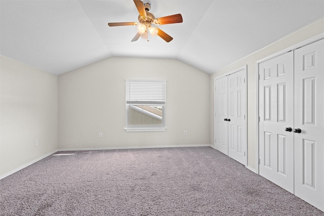 2357 S Branch Rd, Krum, TX 76249 - unfurnished bedroom featuring multiple closets, carpet floors, vaulted ceiling, and a ceiling fan