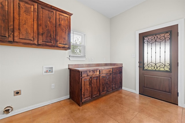 washroom featuring hookup for an electric dryer, cabinet space, hookup for a washing machine, and baseboards