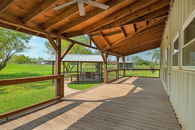 deck with a lawn and ceiling fan