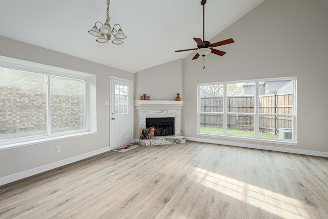 632 Albrook Dr, Allen, TX 75002 - unfurnished living room featuring a stone fireplace, ceiling fan, baseboards, a chandelier, and high vaulted ceiling
