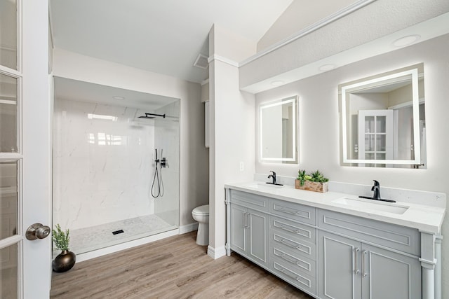 632 Albrook Dr, Allen, TX 75002 - bathroom with double vanity, toilet, walk in shower, lofted ceiling, and wood finished floors