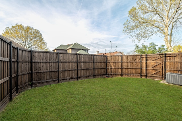view of yard featuring cooling unit and a fenced backyard