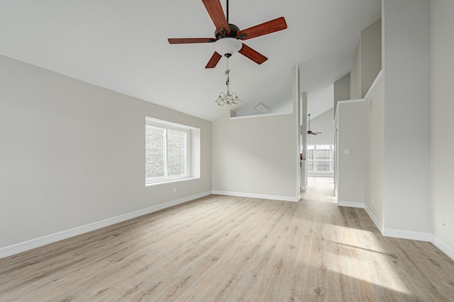 unfurnished room featuring baseboards, vaulted ceiling, wood finished floors, and ceiling fan