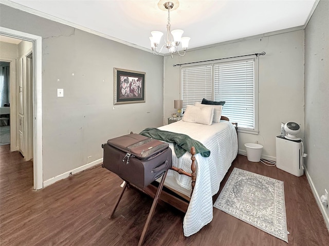 1700 4th St, Brownwood, TX 76801 - bedroom with wood finished floors, an inviting chandelier, and baseboards
