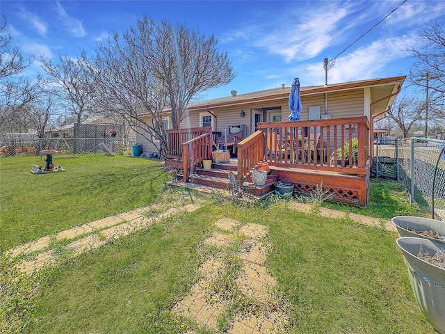 1700 4th St, Brownwood, TX 76801 - back of property with a fenced backyard, a wooden deck, and a lawn