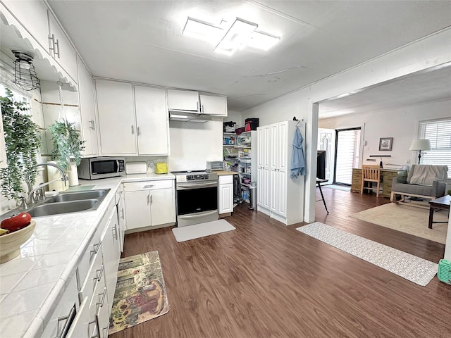 1700 4th St, Brownwood, TX 76801 - kitchen with a sink, appliances with stainless steel finishes, tile countertops, and dark wood finished floors