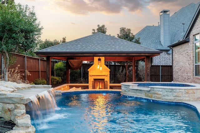 3510 Springbell St, Celina, TX 75009 - view of swimming pool featuring a gazebo, a fenced backyard, a warm lit fireplace, and a pool with connected hot tub