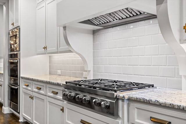 3510 Springbell St, Celina, TX 75009 - kitchen featuring appliances with stainless steel finishes, decorative backsplash, white cabinets, and light stone counters