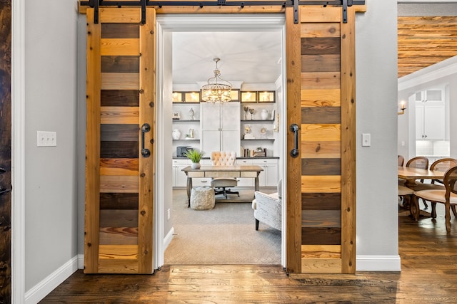 3510 Springbell St, Celina, TX 75009 - corridor with a barn door, dark wood-type flooring, a desk, baseboards, and a chandelier