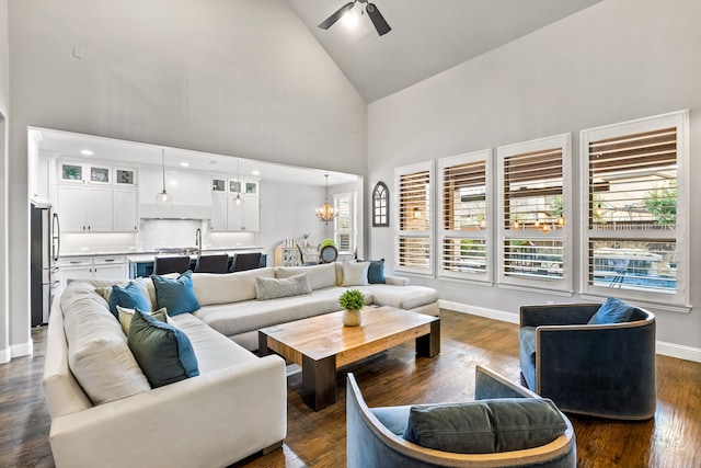 3510 Springbell St, Celina, TX 75009 - living area featuring high vaulted ceiling, a ceiling fan, a chandelier, baseboards, and dark wood-style floors