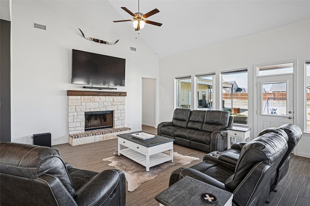 197 Spanish Moss Trl, Rhome, TX 76078 - living room with dark wood-style flooring, a ceiling fan, high vaulted ceiling, a fireplace, and baseboards
