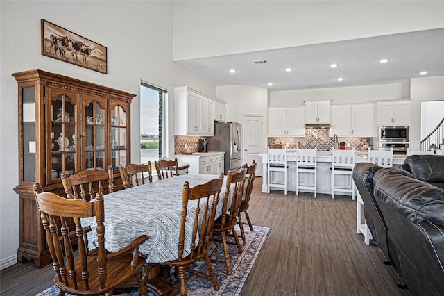 dining space with visible vents, recessed lighting, dark wood-style floors, and stairs