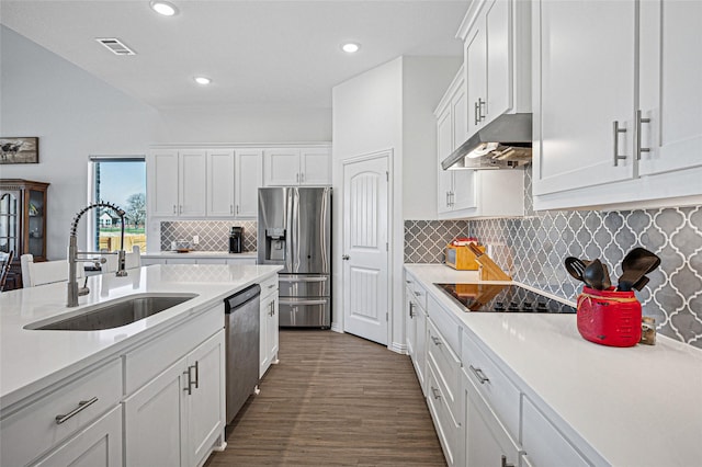 kitchen featuring a sink, under cabinet range hood, visible vents, white cabinets, and appliances with stainless steel finishes
