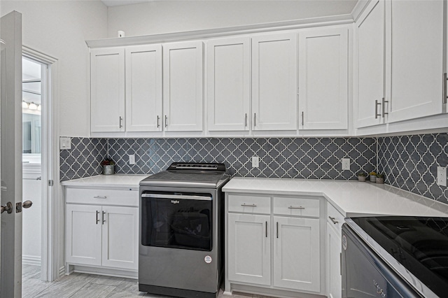clothes washing area featuring cabinet space