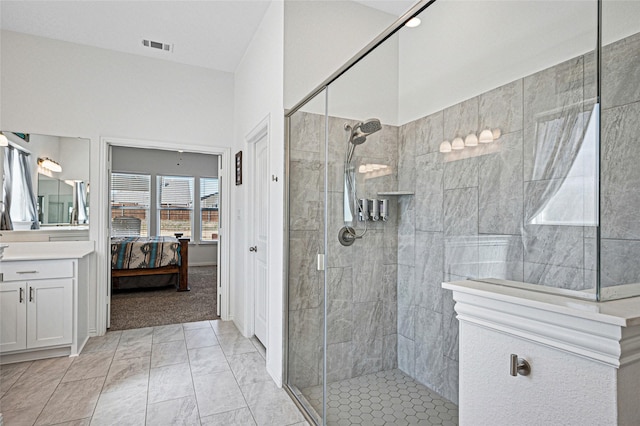 full bathroom with connected bathroom, tiled shower, and vanity