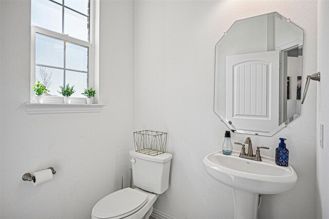 bathroom featuring toilet and a sink
