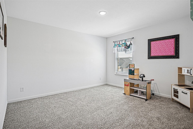 interior space with baseboards, recessed lighting, and carpet flooring
