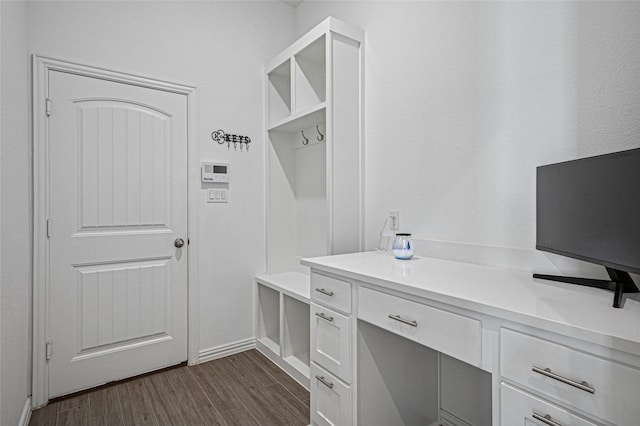 mudroom featuring dark wood-style floors and baseboards